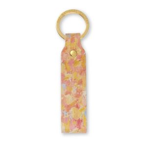 A leather loop keyring showing pink and yellow brushstroke details from Seurat's The Channel of Gravelines, Grand Fort-Philippe. The gold colour ring has The National Gallery engraved on it.
