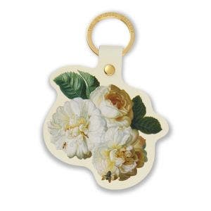 A gold loop keyring made from leather. Showing an image of flowers.