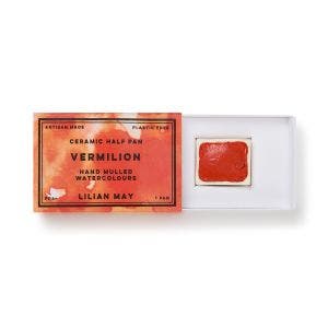 An open box of Vermilion watercolour paint.