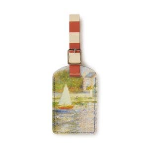 A luggage tag made from recycled leather with a silver clasp and blue stitching.