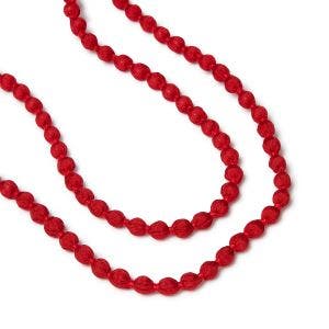 Close up of two strands of red beads on a necklace.