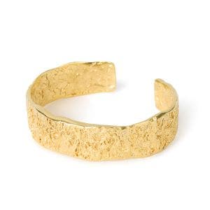 A wide gold-plated cuff bracelet with a texture design