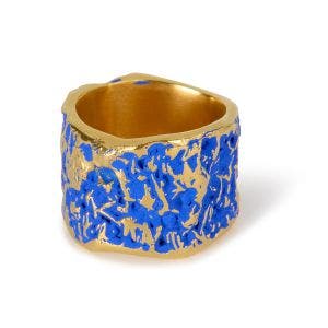 A gold-plated wide ring with a blue texture design
