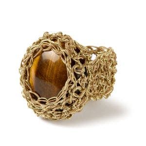A side view of a gold wire ring.