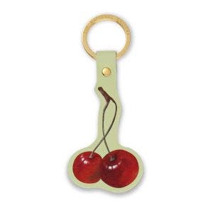 A gold loop and leather keyring showing red cherries.