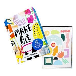 An opened Make Art box with colorful patterns on the cover, filled with sticker sheets and fun art projects for kids to enjoy.