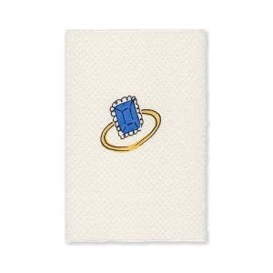 A white illustrated card of a gold bang ring with a sapphire.