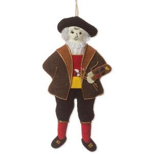 A decoraiton made from felt and thread showing a man in a hat and brown coat holding a paint palette and paint brushes.