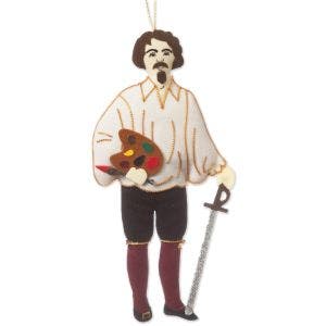 An embroidered decoration of Caravaggio holding a paint palette and sword.